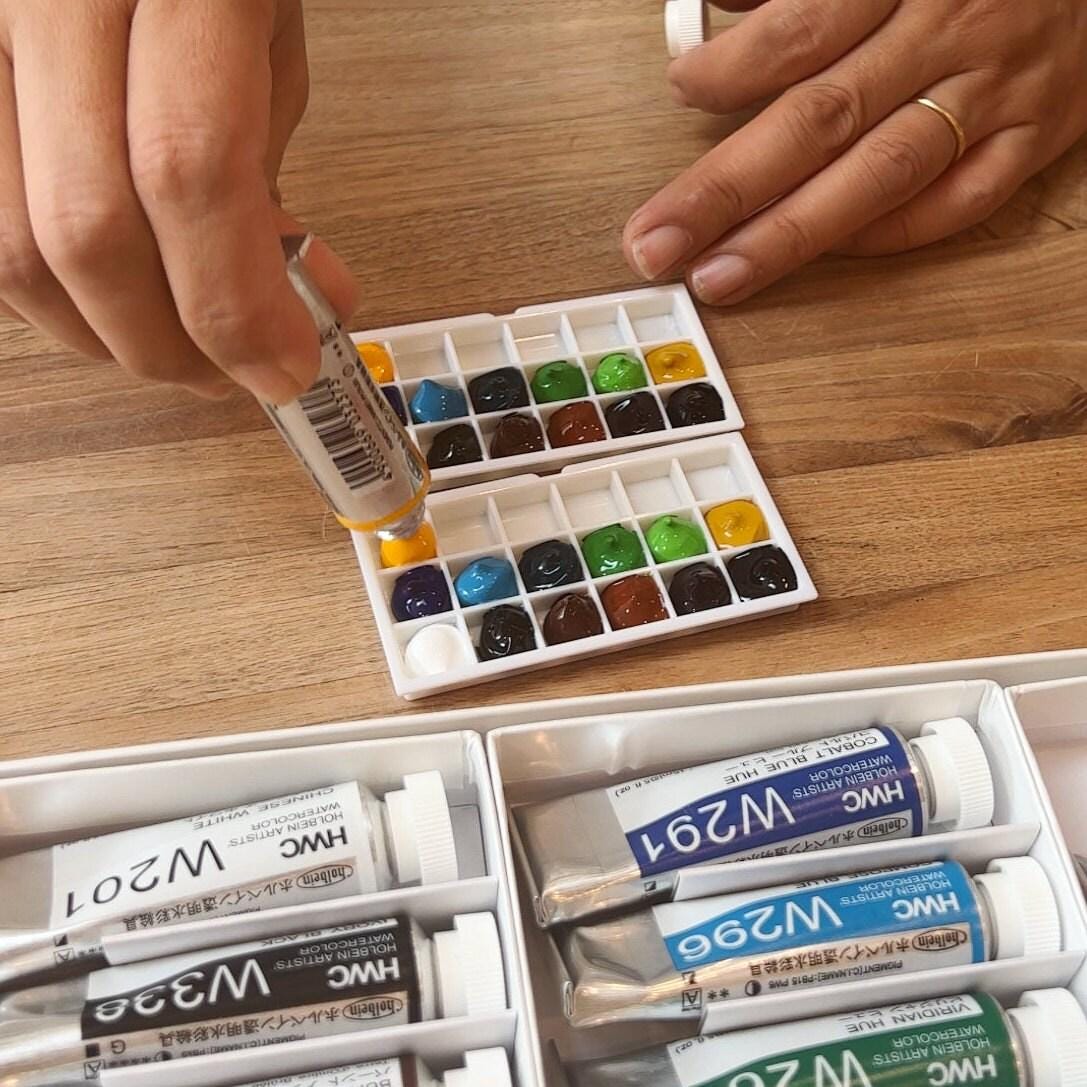 	Pos 8: Holbein luminous neon palette in hand - travel art kit