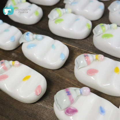 Pos 3: Watercolor brushes on monogrammed ceramic brush rest